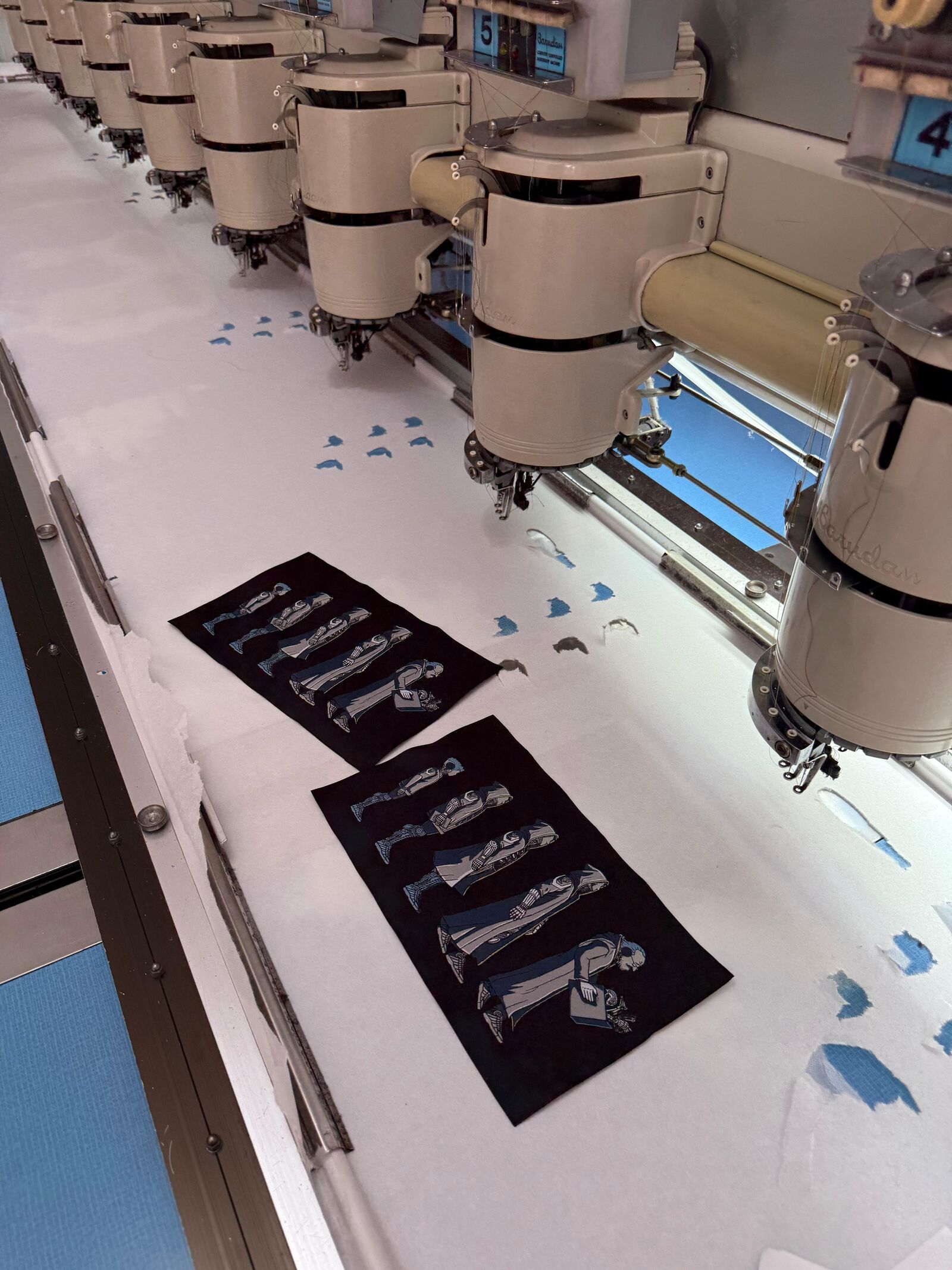 Industrial multi-head embroidery machine stitching designs onto fabric