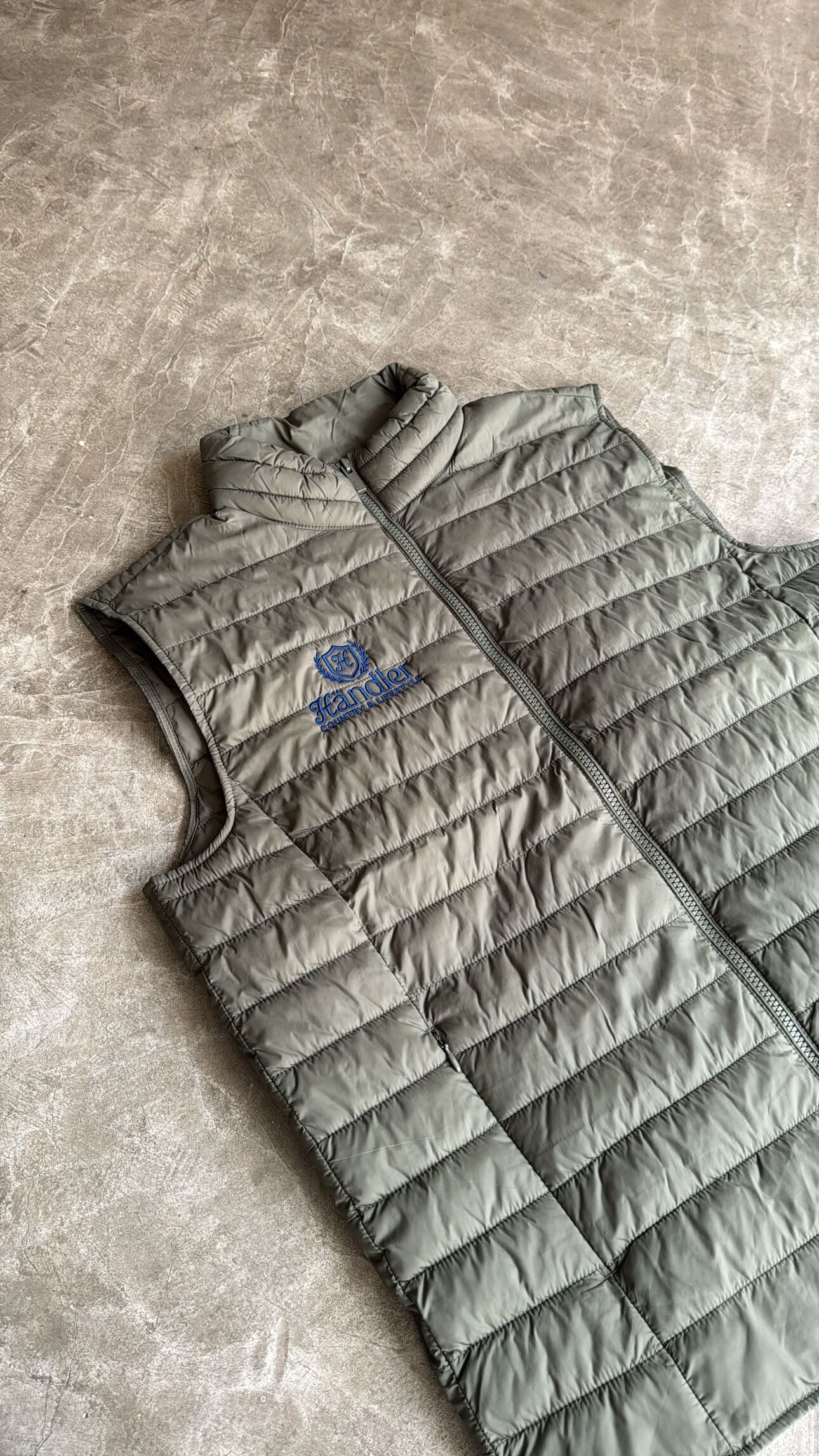 Olive green quilted padded vest with blue embroidered brand logo