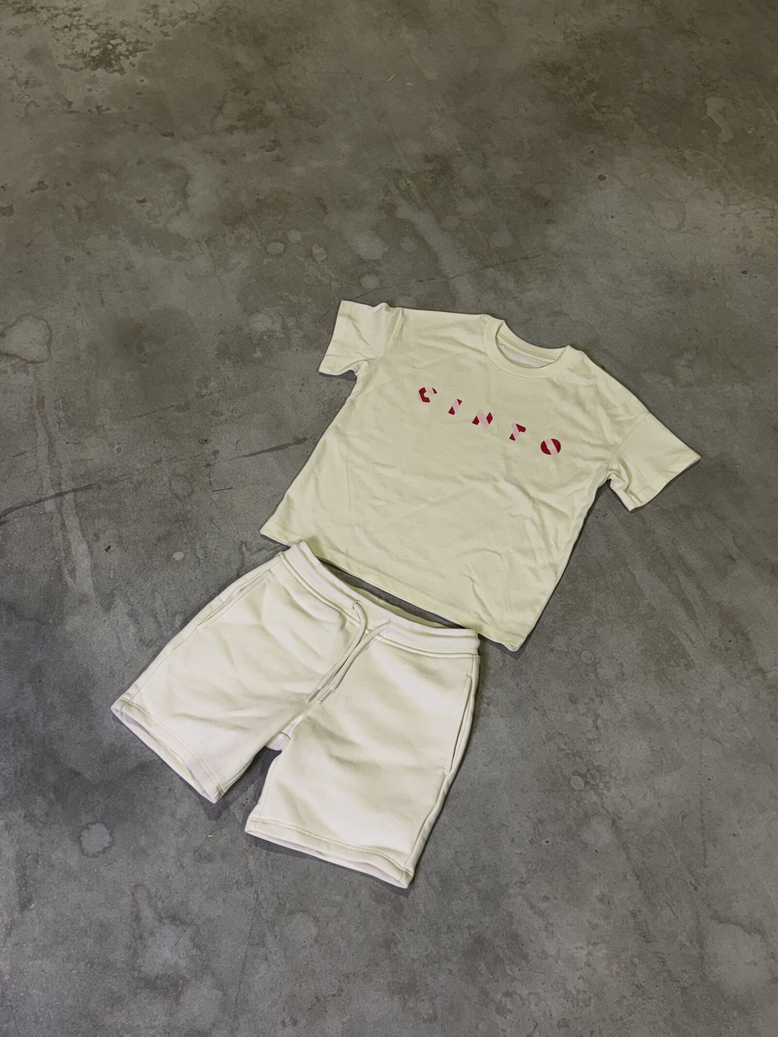 Off-white children's set with red printed lettering and matching shorts
