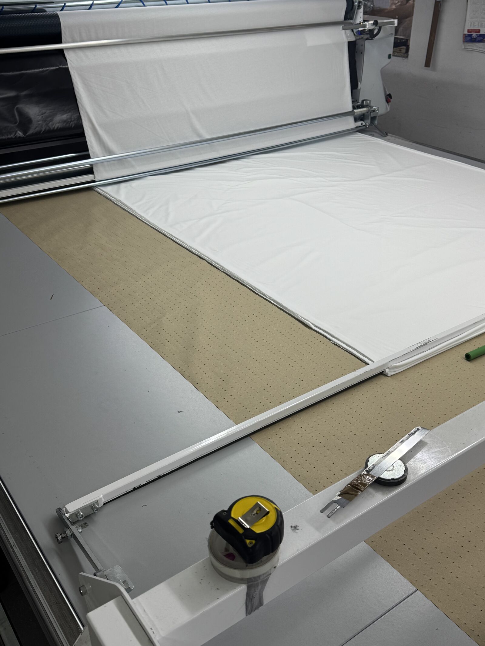 Fabric cutting table with industrial spreader