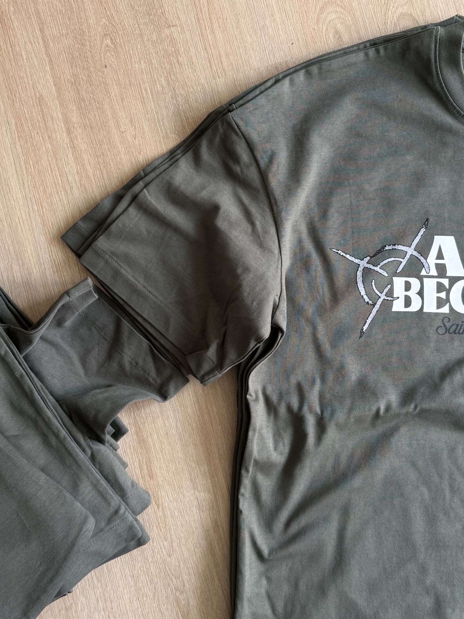 Olive-green branded streetwear set with t-shirt and matching shorts