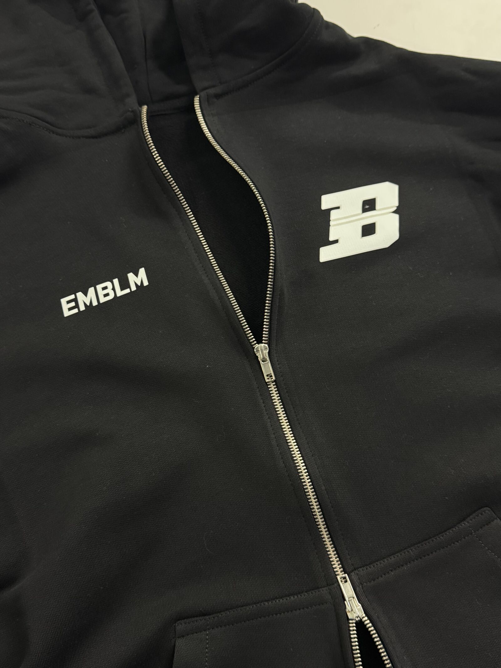 Black EMBLM hoodie with raised rubber logo patch detail